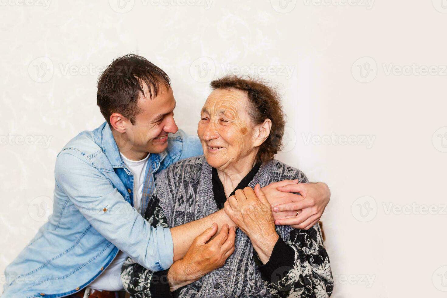 Closeup of elderly woman with young man photo