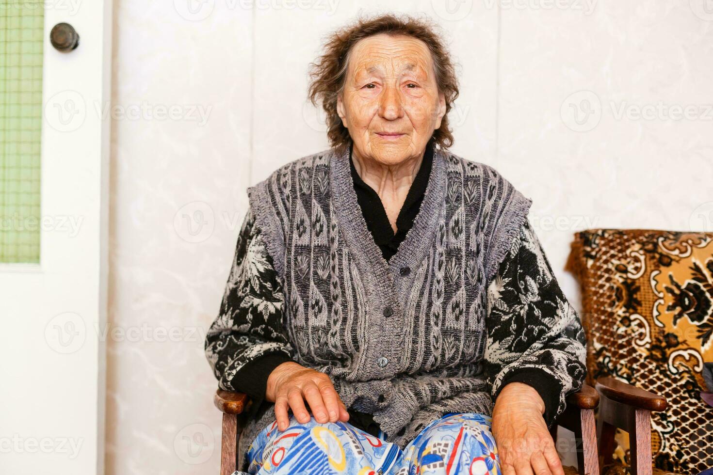 Senior Woman Relaxing In Chair At Home photo