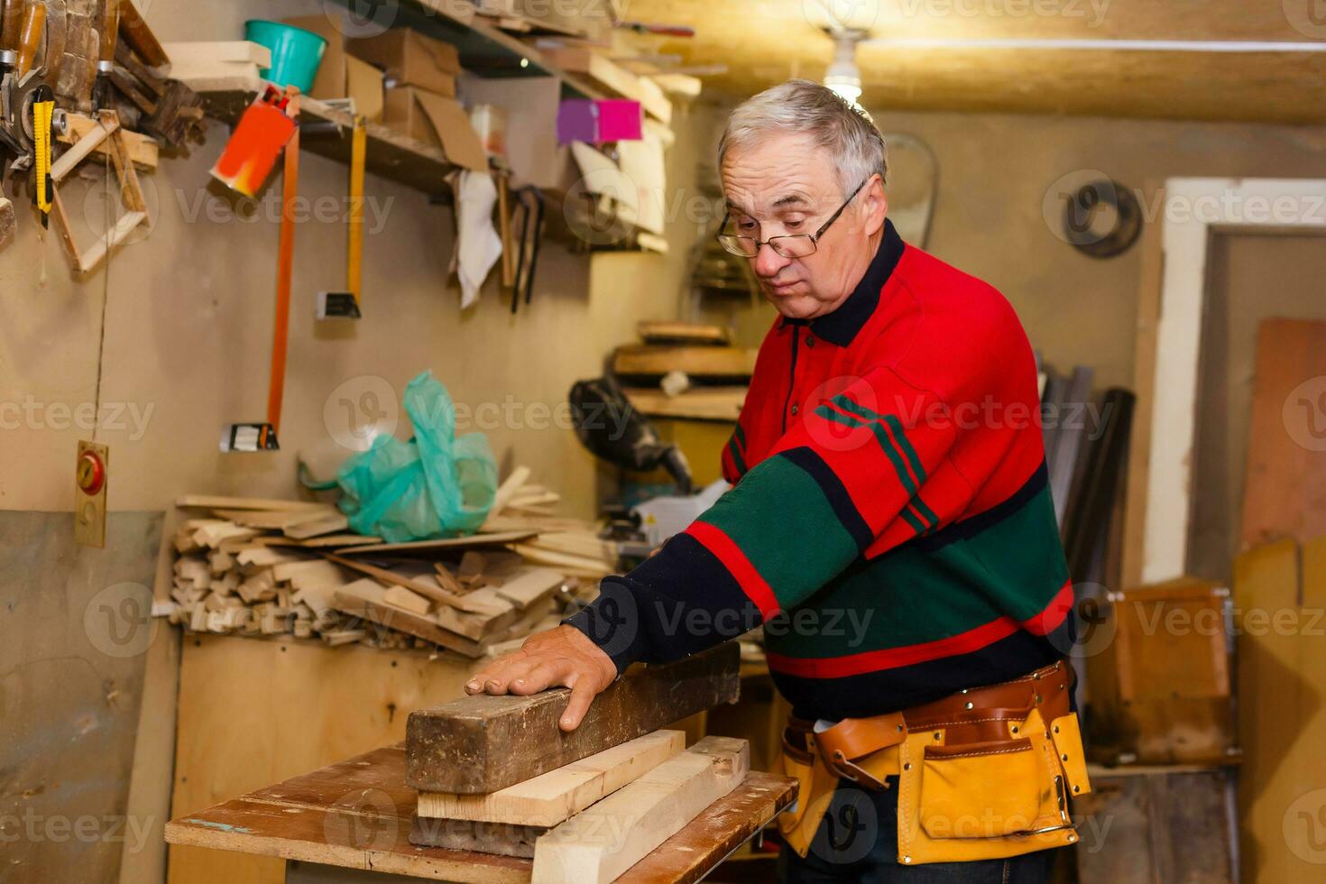 Carpenter works in a workshop for the production of vintage furniture photo