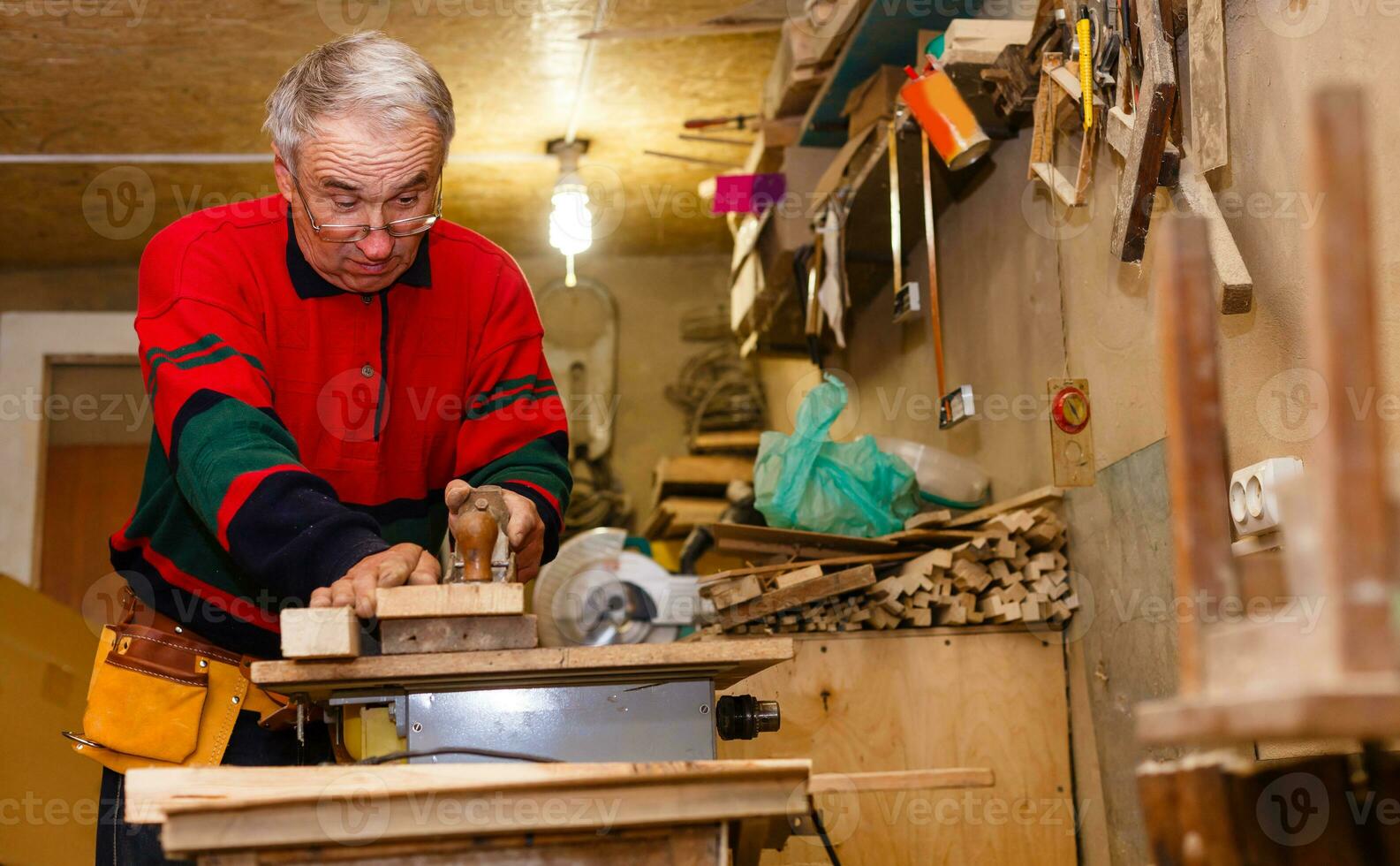 Carpenter works in a workshop for the production of vintage furniture photo