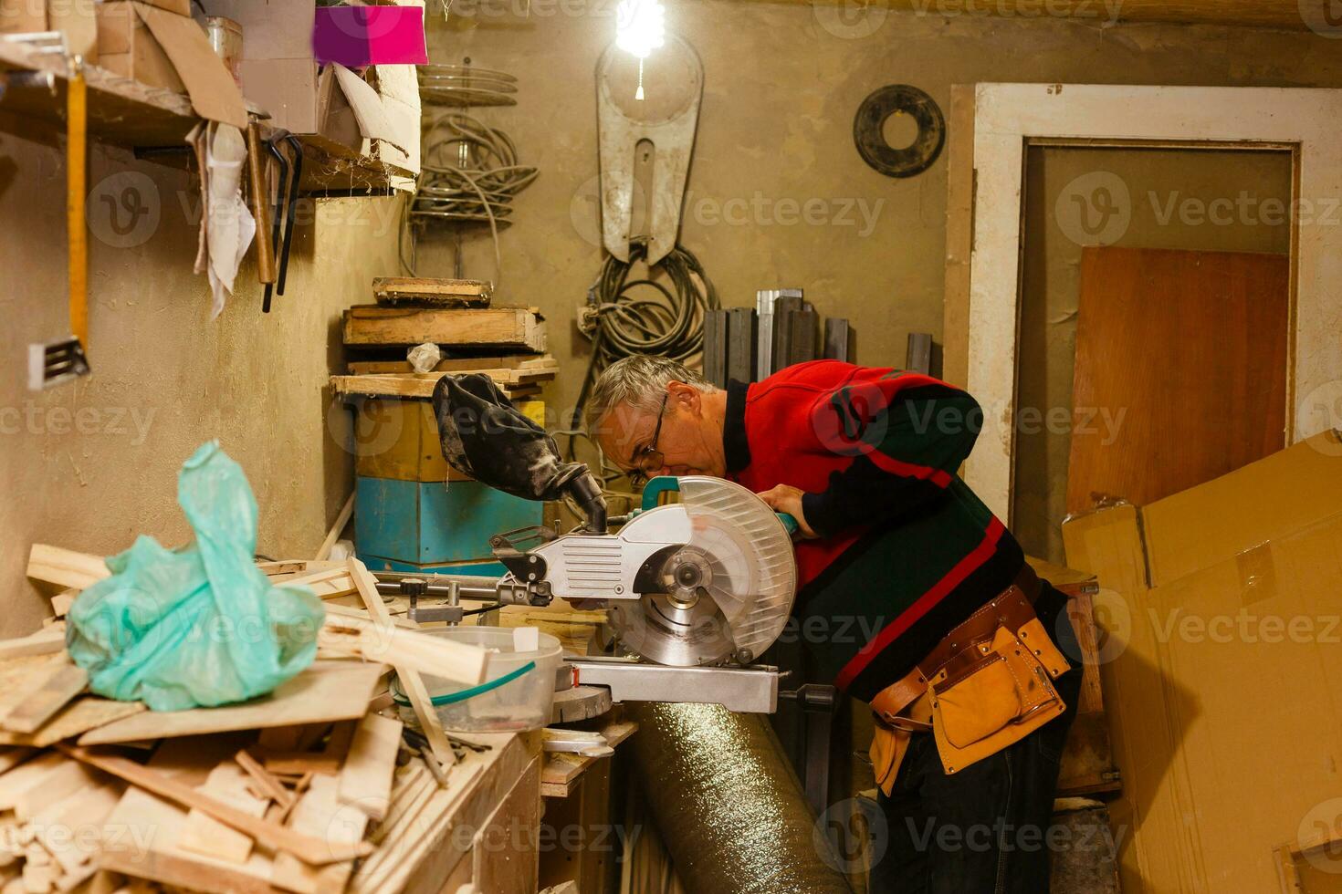 Carpenter works in a workshop for the production of vintage furniture photo