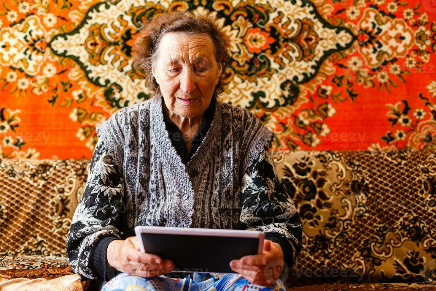 Senior woman browsing on digital tablet photo