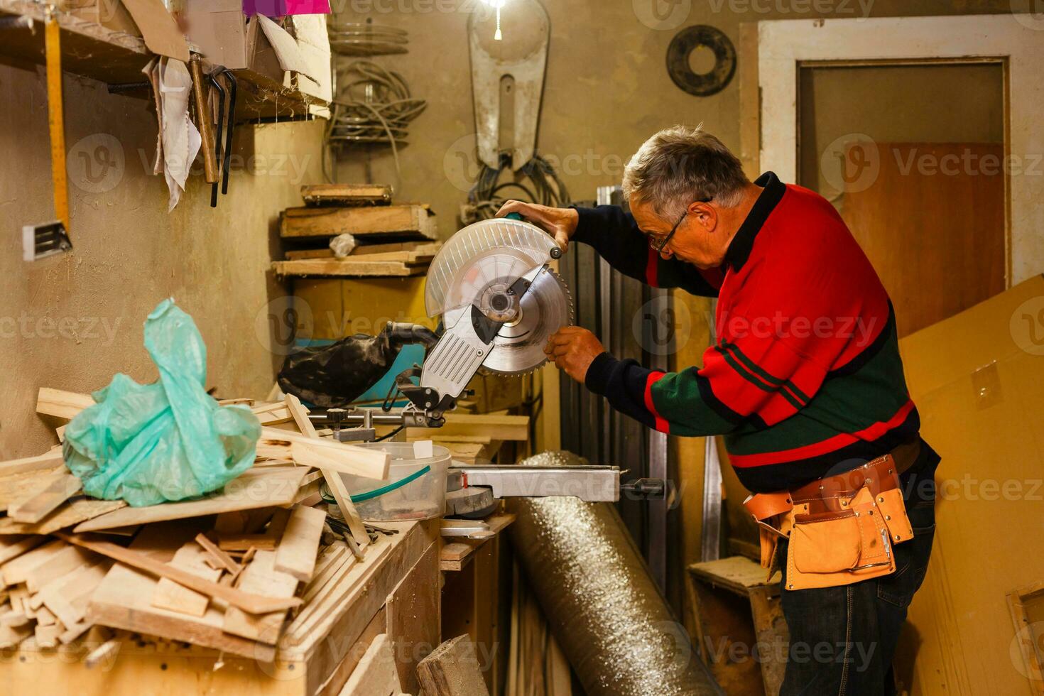 Carpenter works in a workshop for the production of vintage furniture photo