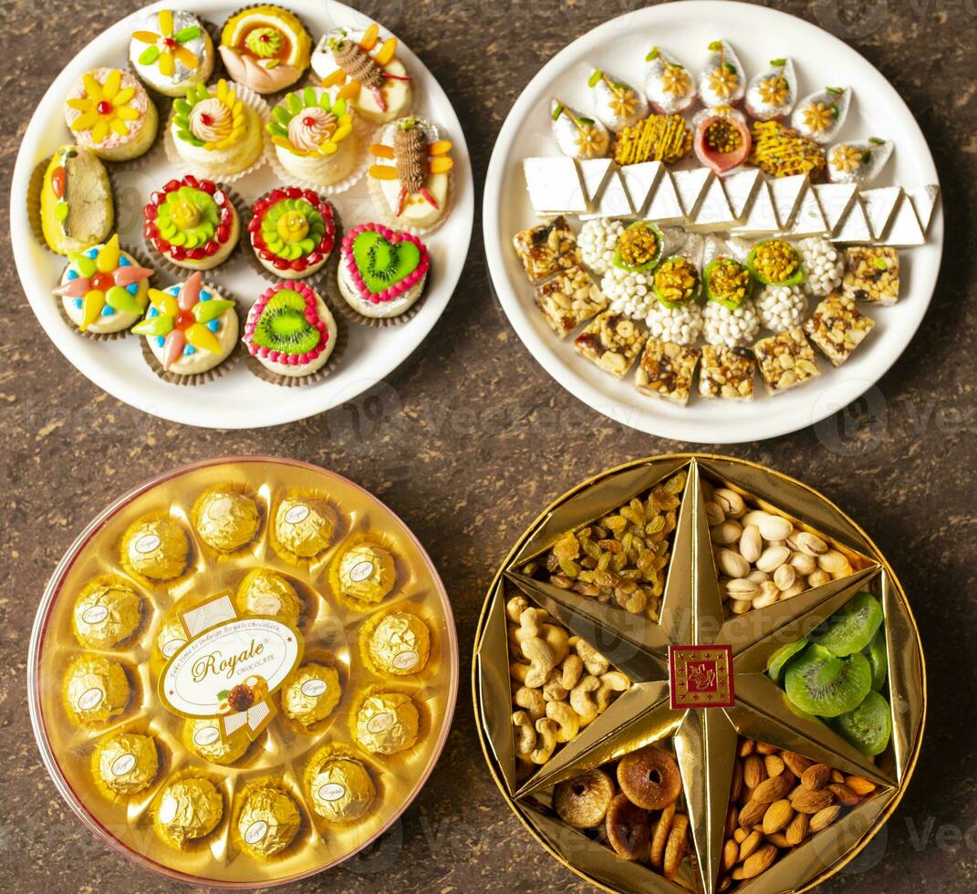 Indian Traditional Mix Sweets Food Served in Special Decorative Plate on Vintage Background photo