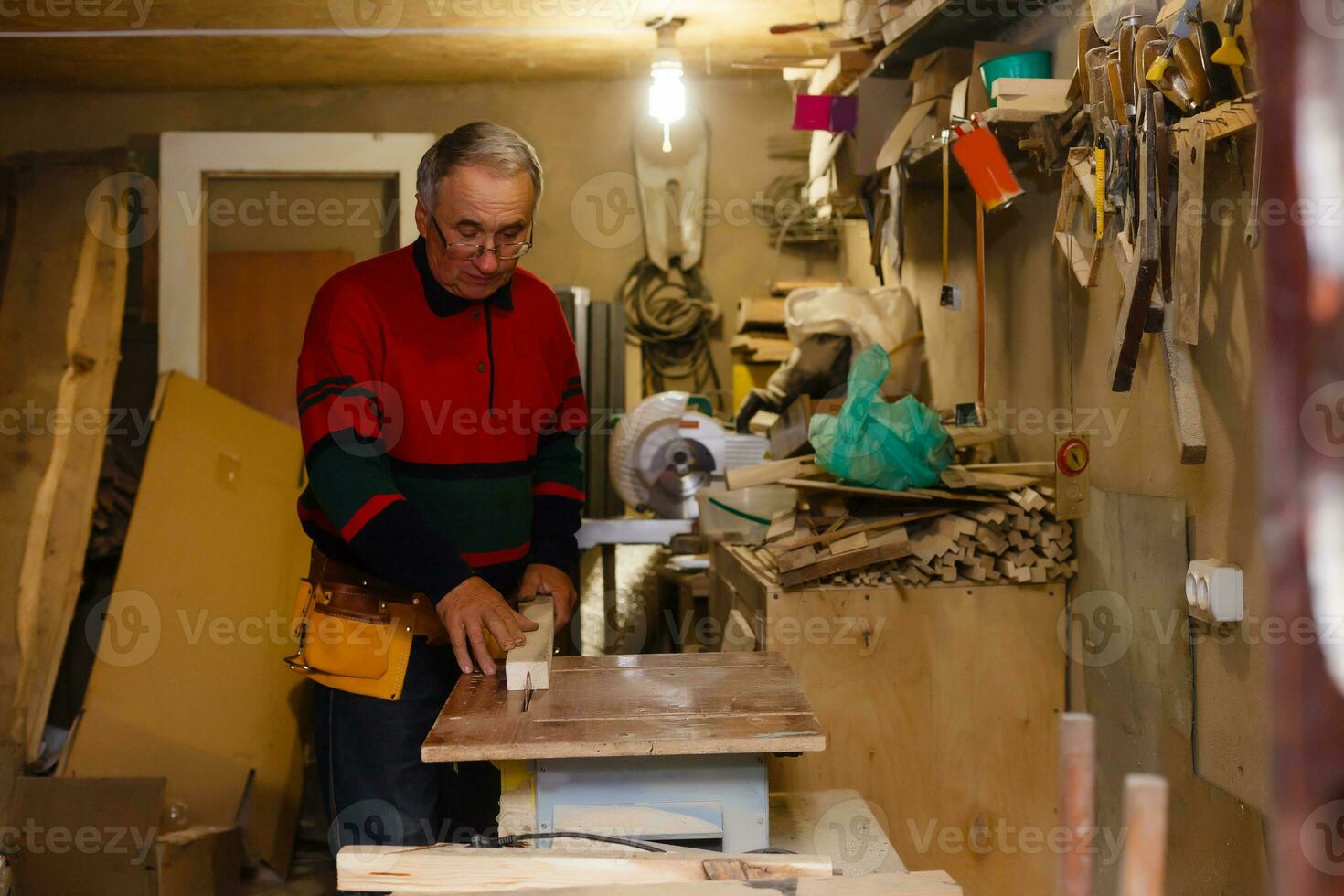 Carpenter doing his job in carpentry workshop. photo