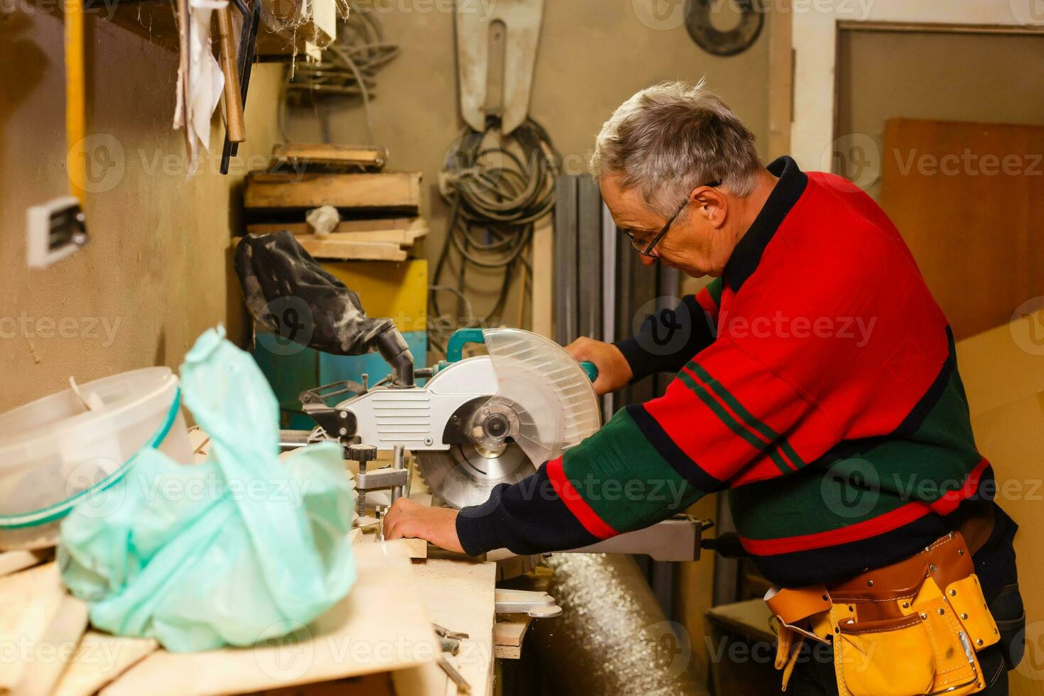 Carpenter doing his job in carpentry workshop. photo