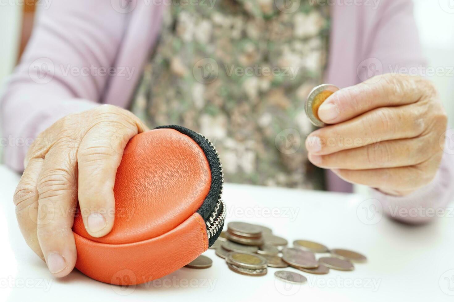 Retired elderly woman counting coins money and worry about monthly expenses and treatment fee payment. photo