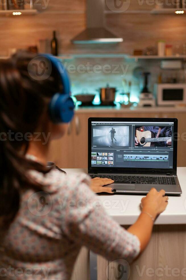 Movie maker editing a film using modern software for post production. Content creator in home working on montage of film using modern software for editing late at night. photo