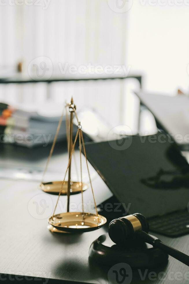 Business and lawyers discussing contract papers with brass scale on desk in office. Law, legal services, advice, justice and law concept picture with film grain effect photo