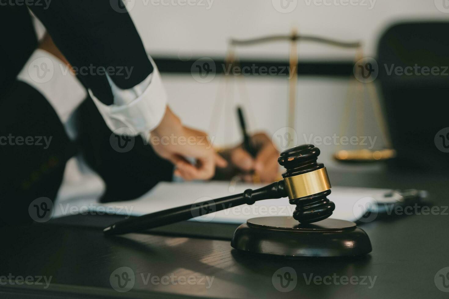 Business and lawyers discussing contract papers with brass scale on desk in office. Law, legal services, advice, justice and law concept picture with film grain effect photo