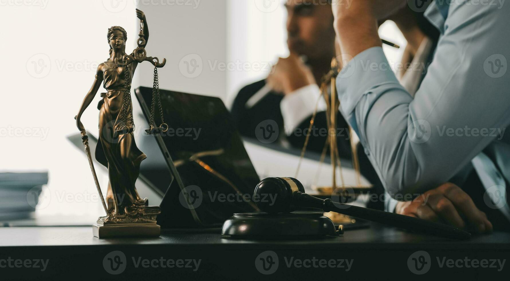 Business and lawyers discussing contract papers with brass scale on desk in office. Law, legal services, advice, justice and law concept picture with film grain effect photo
