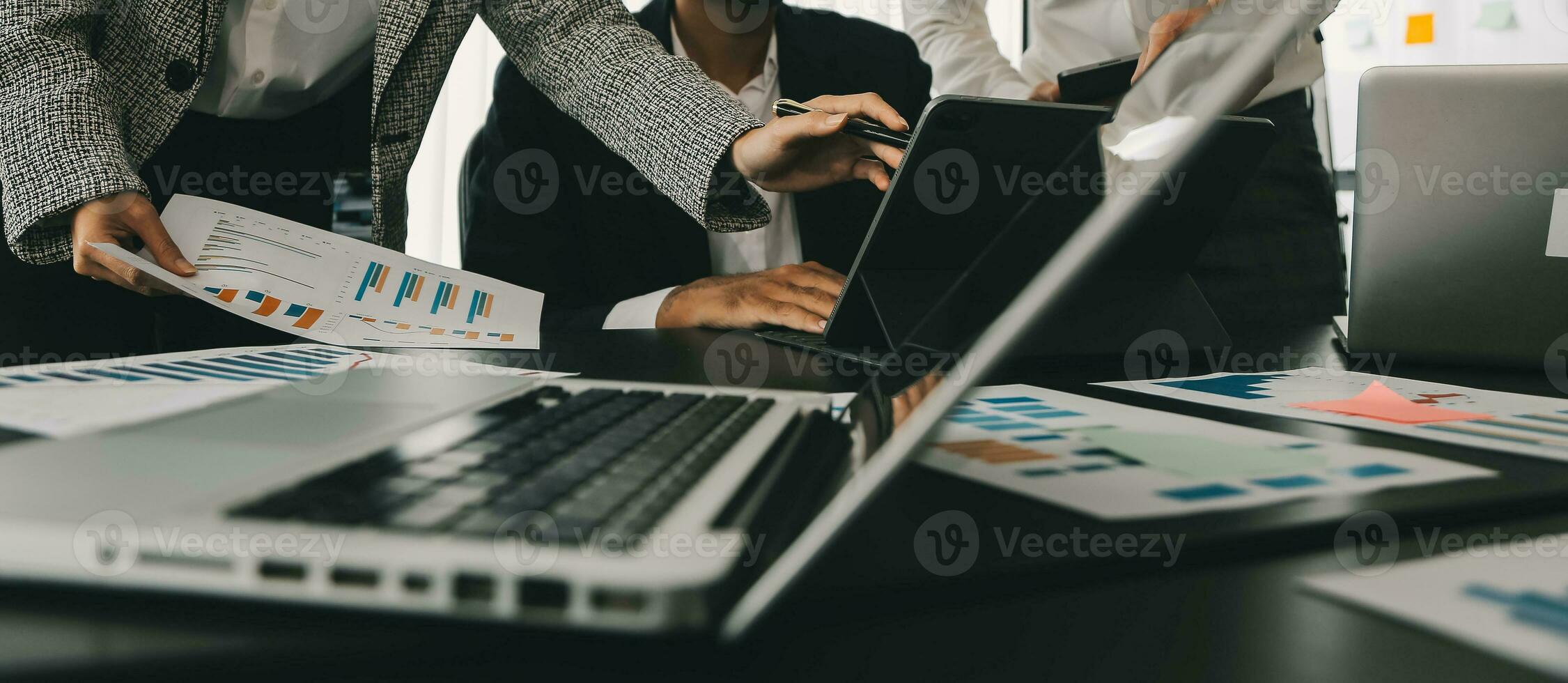 Close up of Business team analyzing income charts and graphs with modern laptop computer. Business analysis and strategy concept. photo