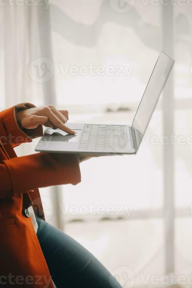 Close up Business woman using calculator and laptop for do math finance on wooden desk, tax, accounting, statistics and analytical research concept photo