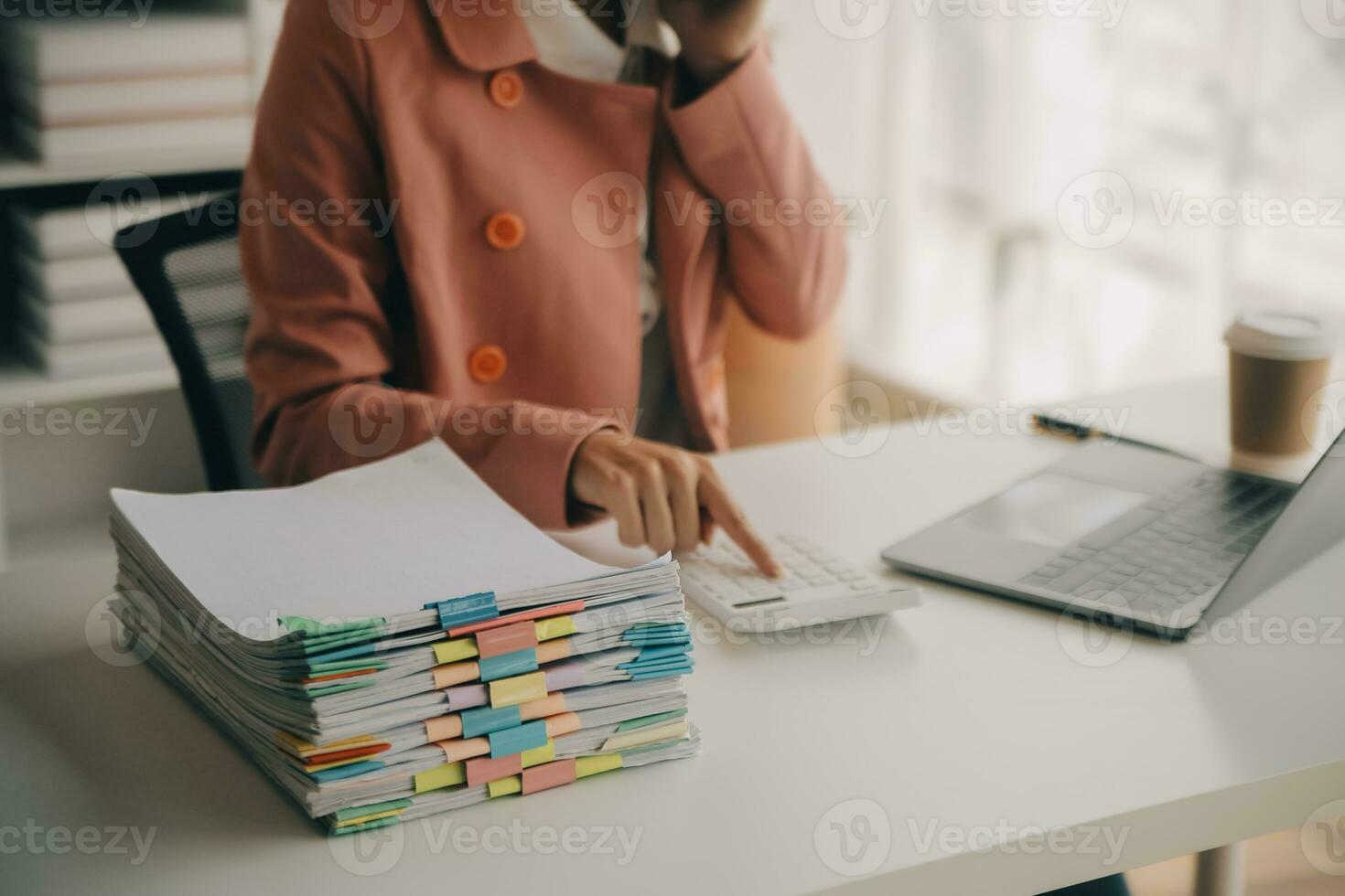 Close up Business woman using calculator and laptop for do math finance on wooden desk, tax, accounting, statistics and analytical research concept photo