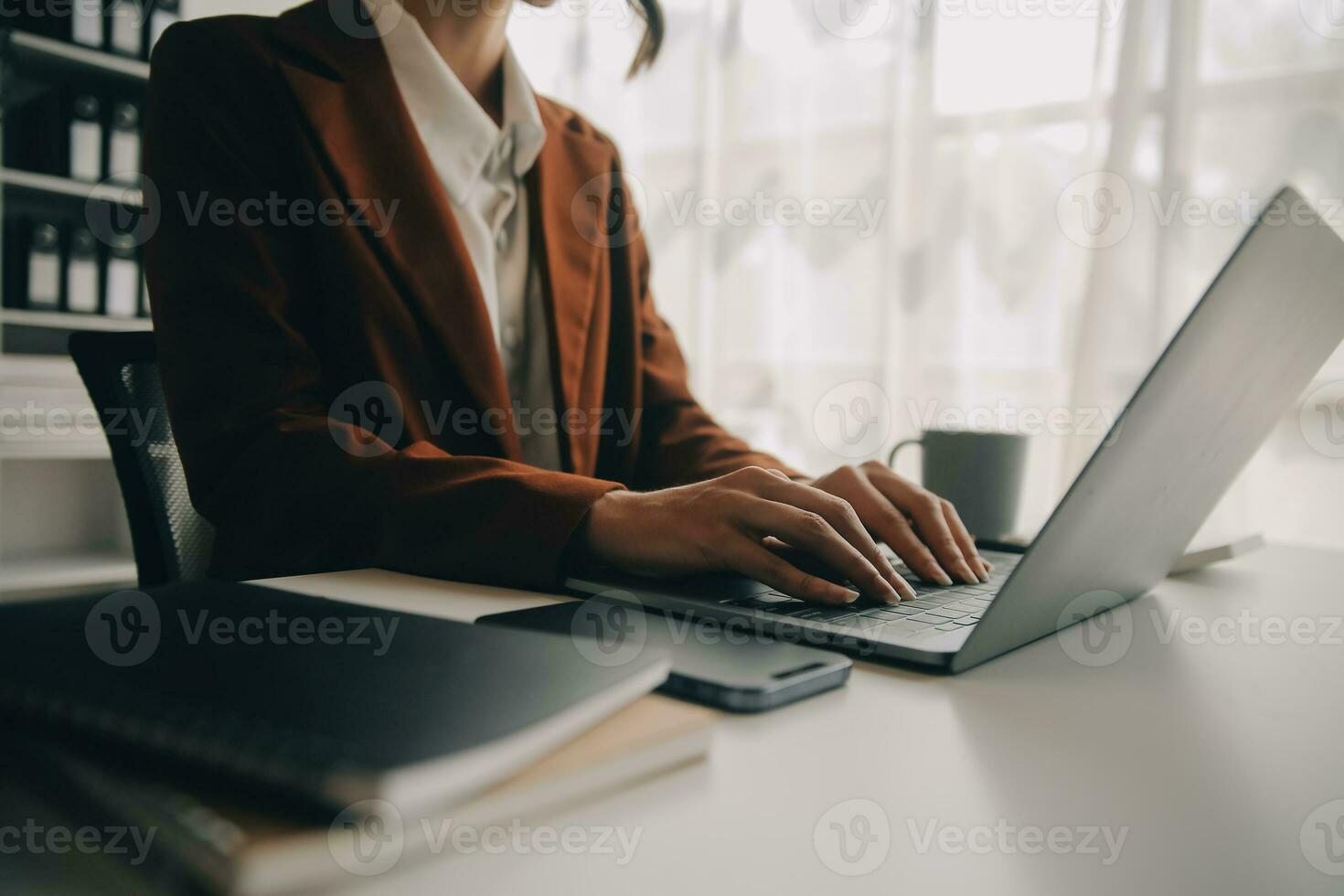 Close up Business woman using calculator and laptop for do math finance on wooden desk, tax, accounting, statistics and analytical research concept photo