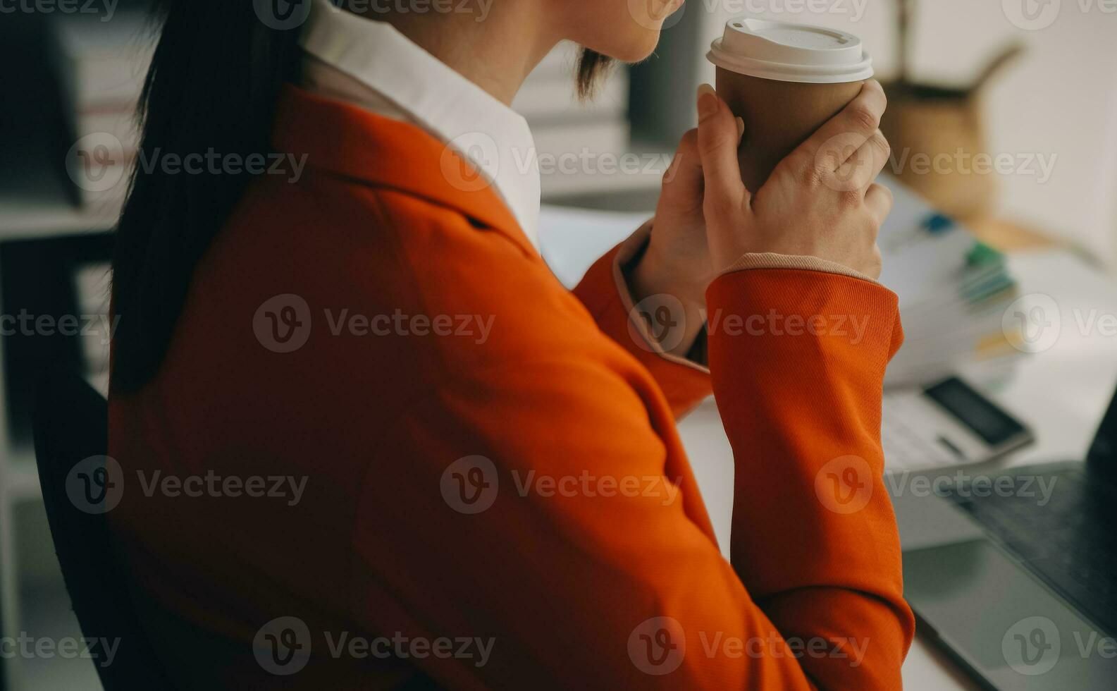 Beautiful female call center operator working on computer in office photo