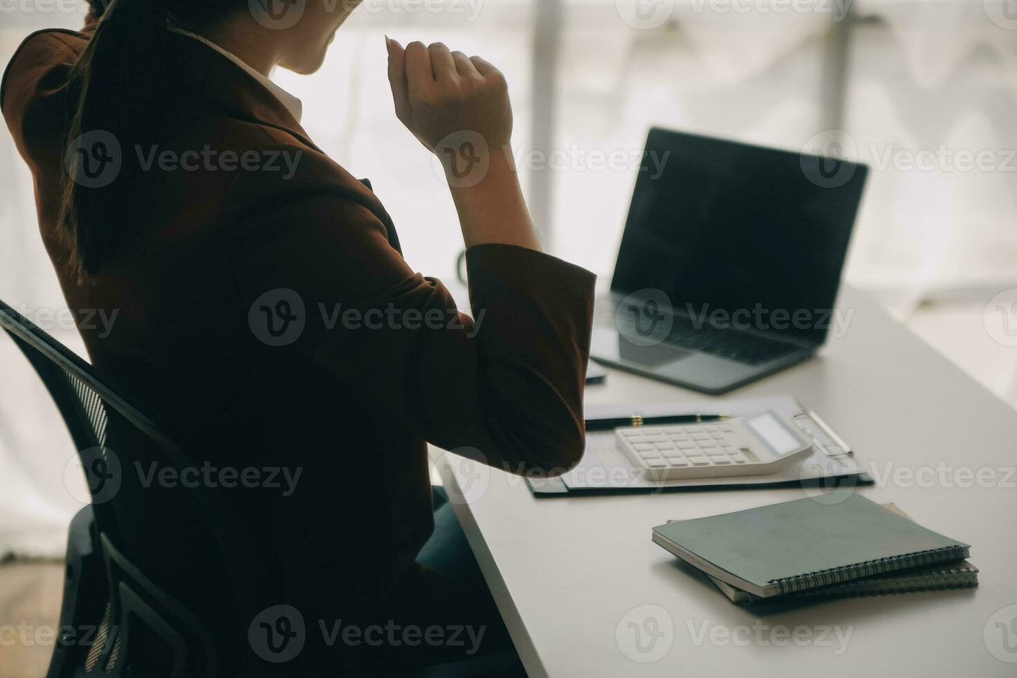 Close up Business woman using calculator and laptop for do math finance on wooden desk, tax, accounting, statistics and analytical research concept photo
