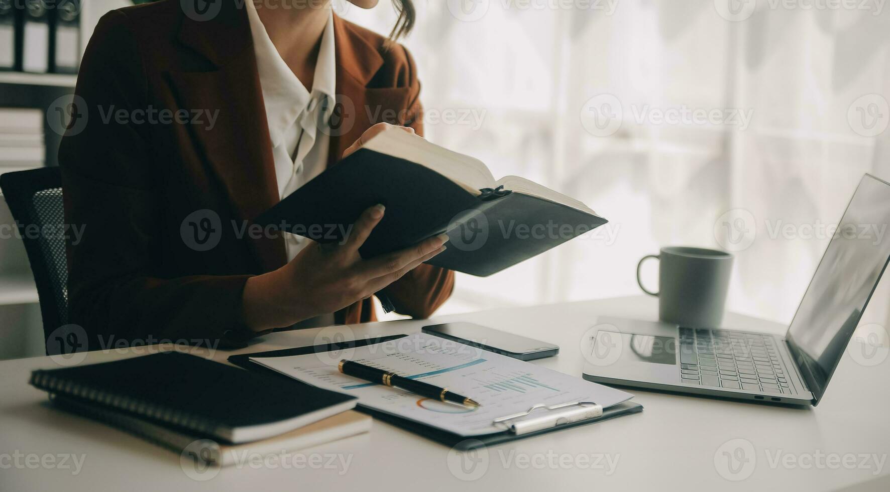 Beautiful female call center operator working on computer in office photo