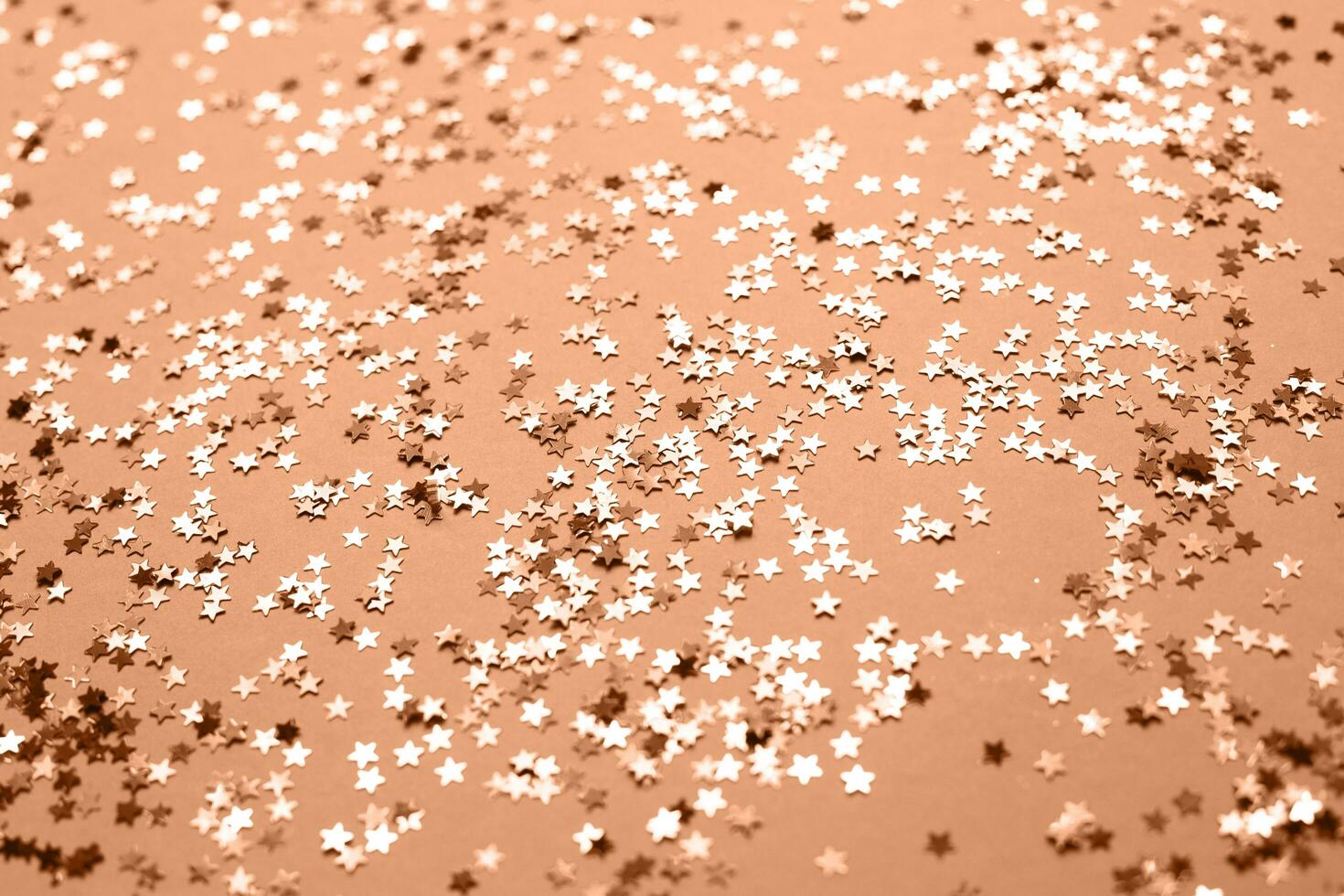 Peach Fuzz sparkles on a purple background. Festive backdrop for your projects. photo