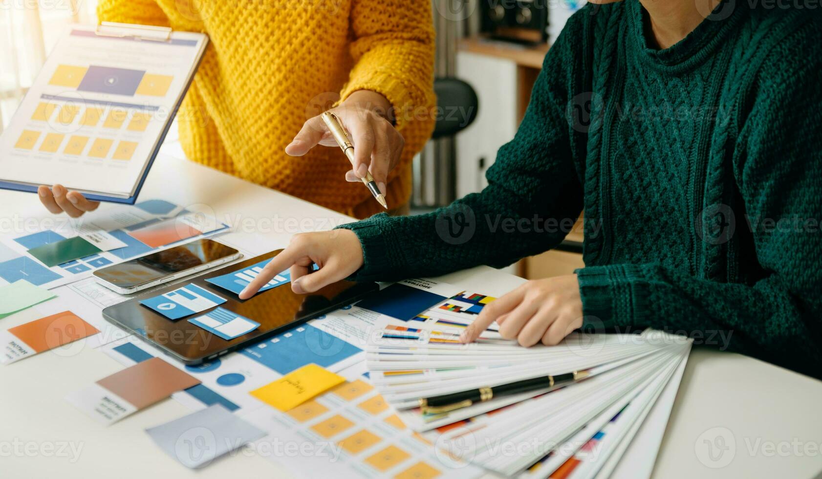 UX developer and ui designer brainstorming about mobile app interface wireframe design with customer breif and color code photo