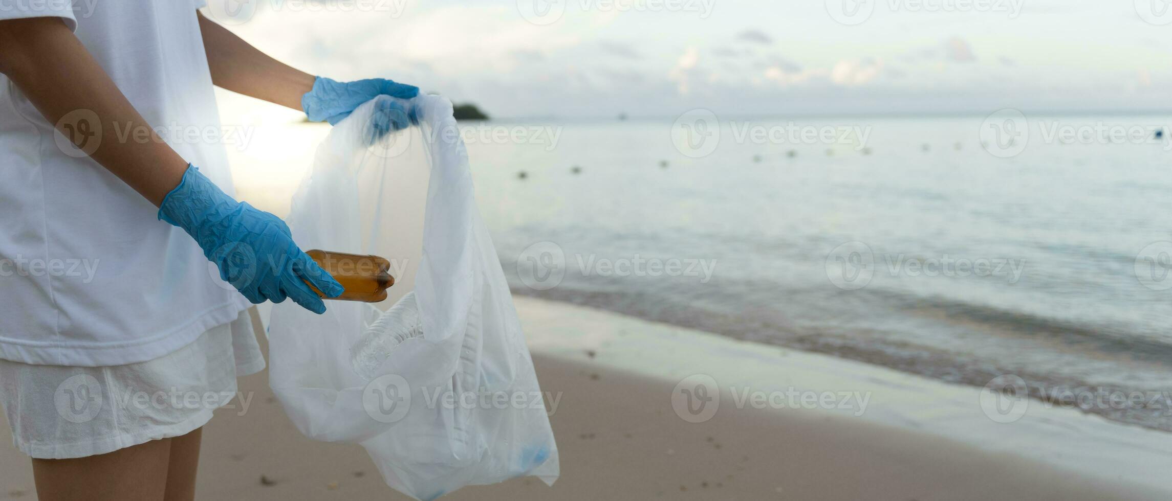 Save water. Volunteer pick up trash garbage at the beach and plastic bottles are difficult decompose prevent harm aquatic life. Earth, Environment, Greening planet, reduce global warming, Save world photo