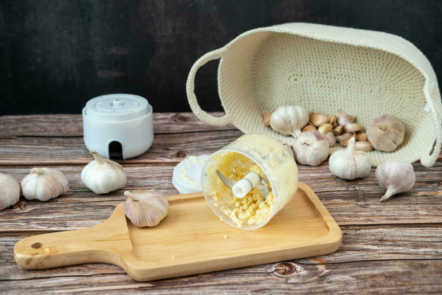 Garlic from a fine blender on a wooden plate photo