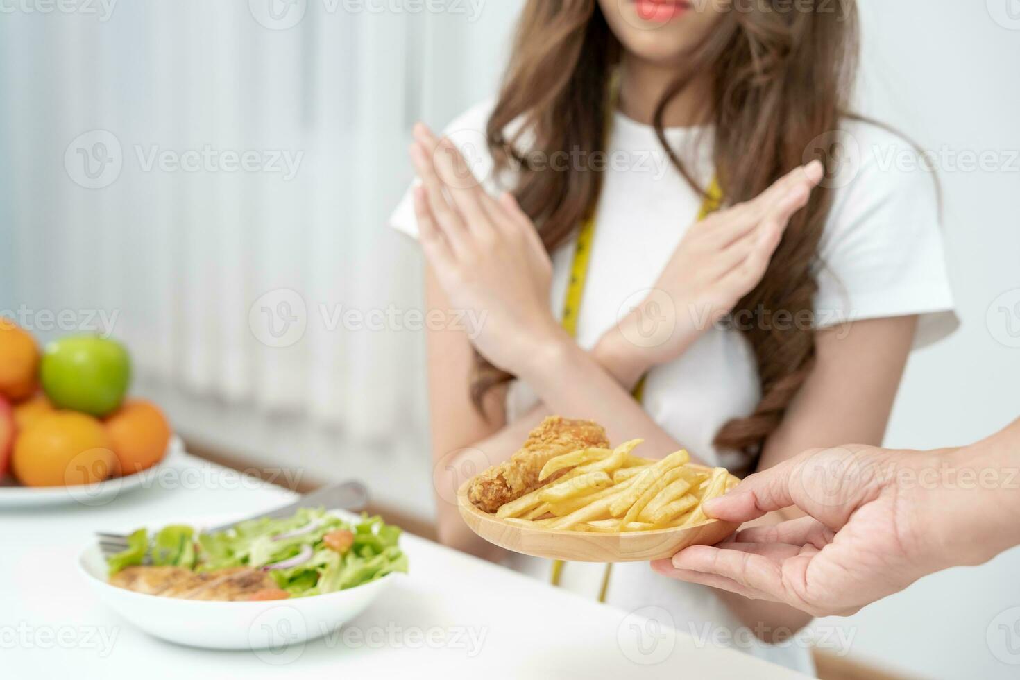 Beauty slim female body confuse French fries and fried chicken. Woman in restaurant achieves weight loss goal for healthy life, crazy about thinness, thin waist, nutritionist. Diet, body shape. photo