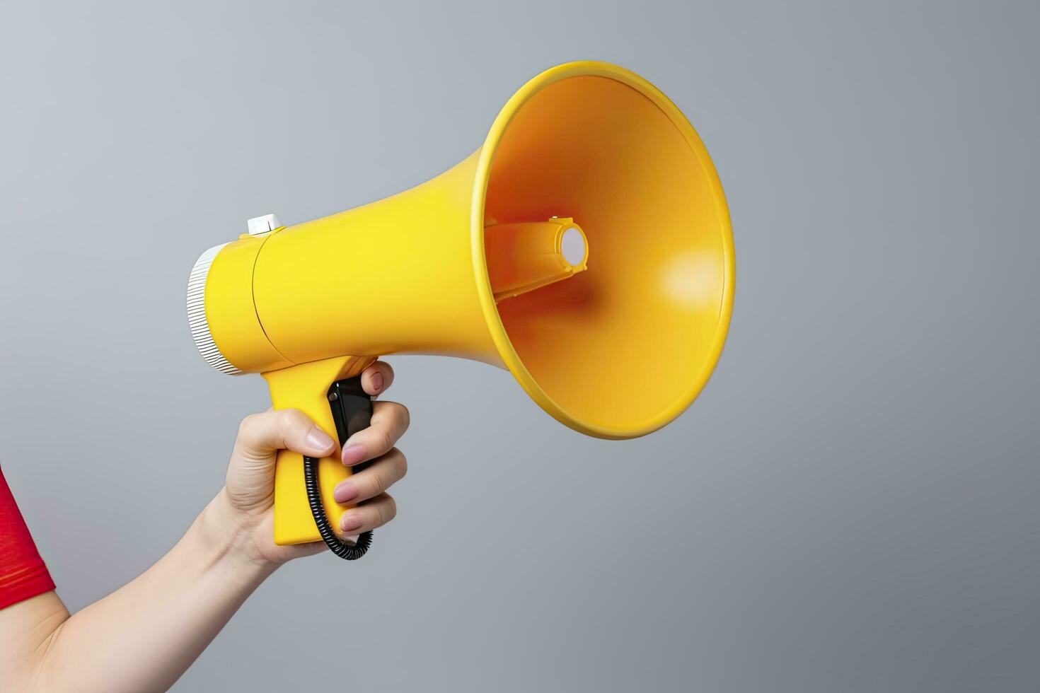 AI generated Empowered Voice Young Woman's Hand Holding a Megaphone with Copy Space on a Gray Background. photo