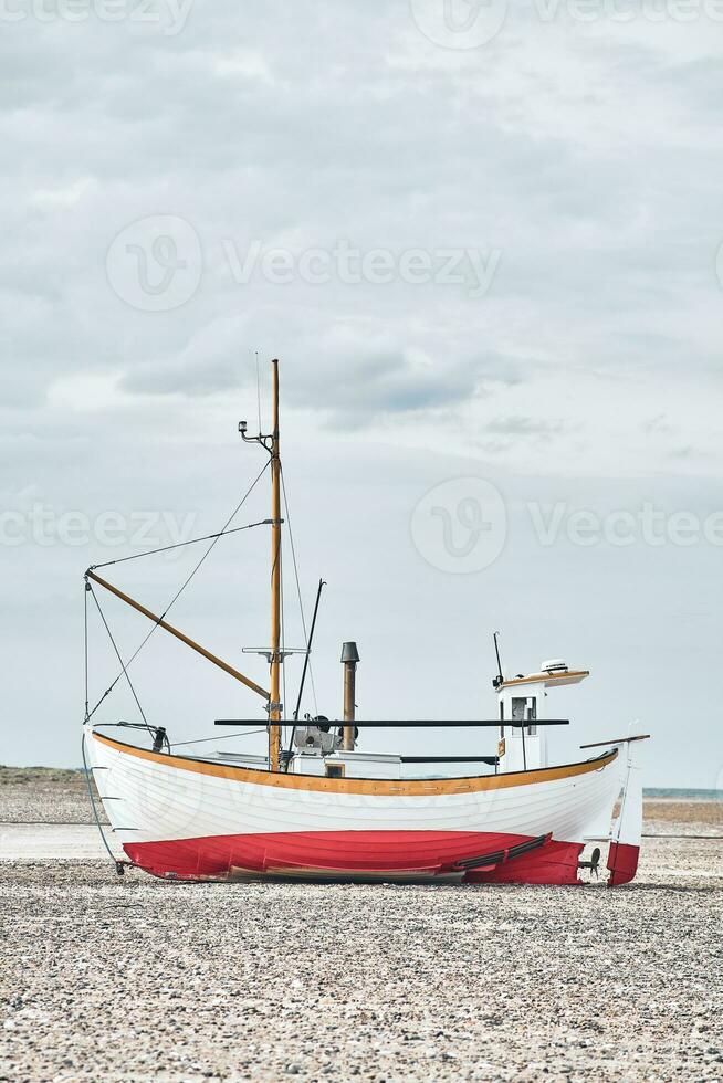 Side view of fishing boat on the beach photo