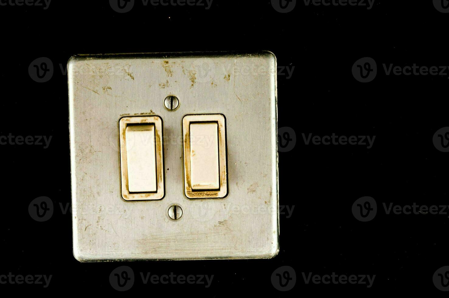 a close up of a light switch with two switches photo
