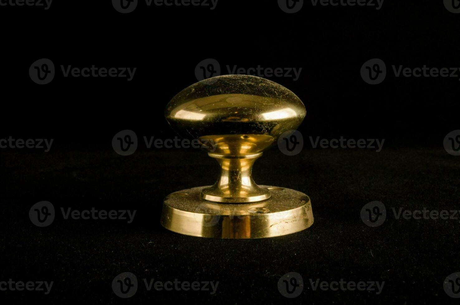 a brass knob on a black background photo