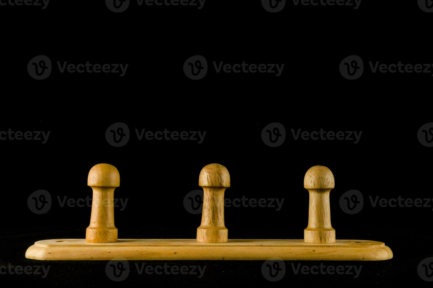 three wooden pegs on a black background photo