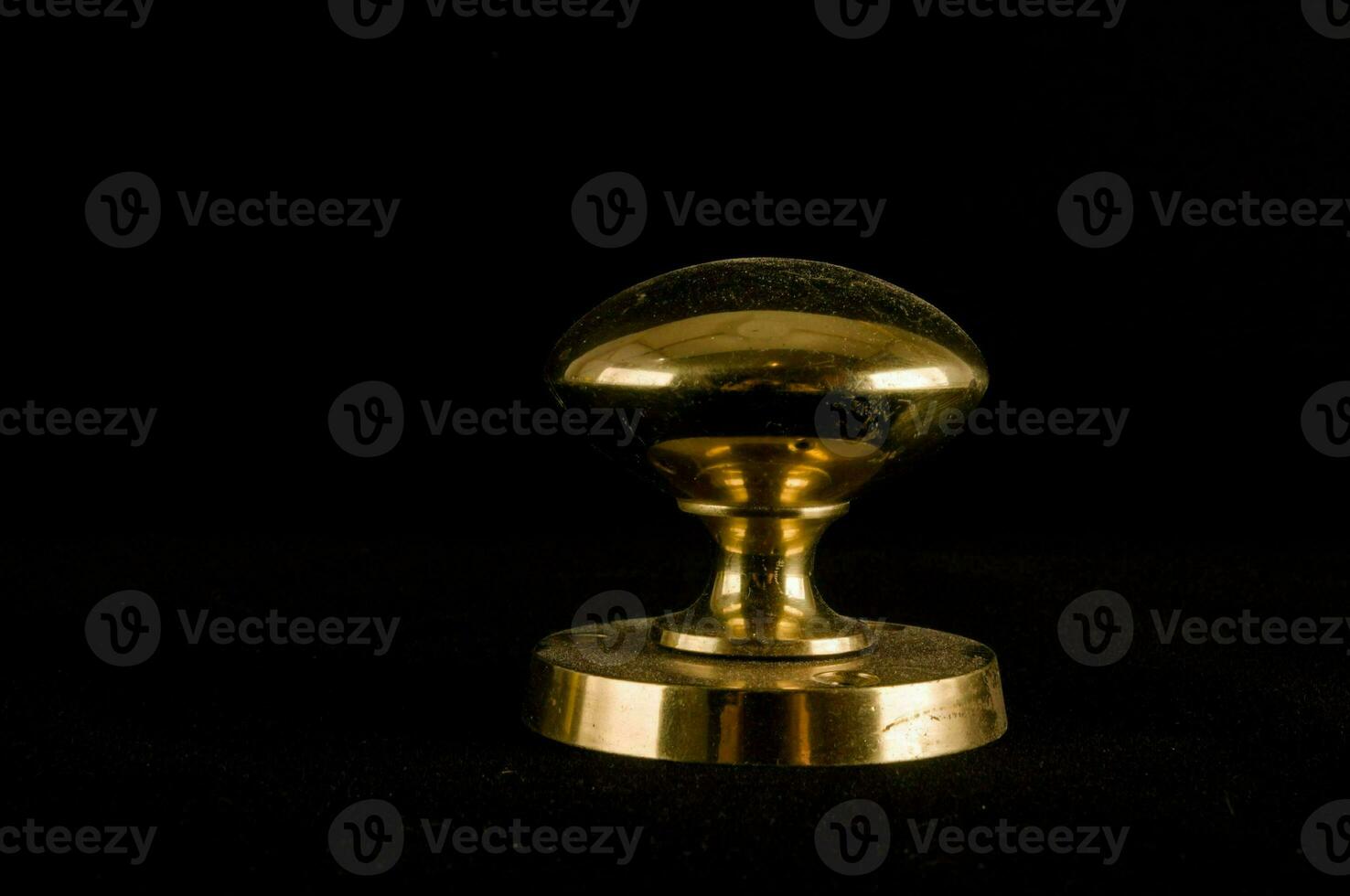 a brass knob on a black background photo