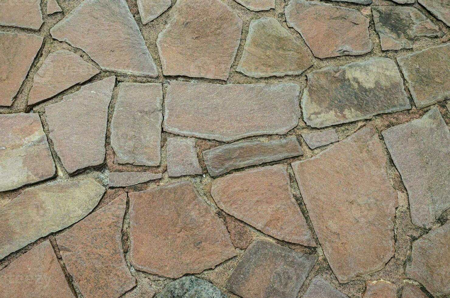 a stone wall with many different shapes and sizes photo