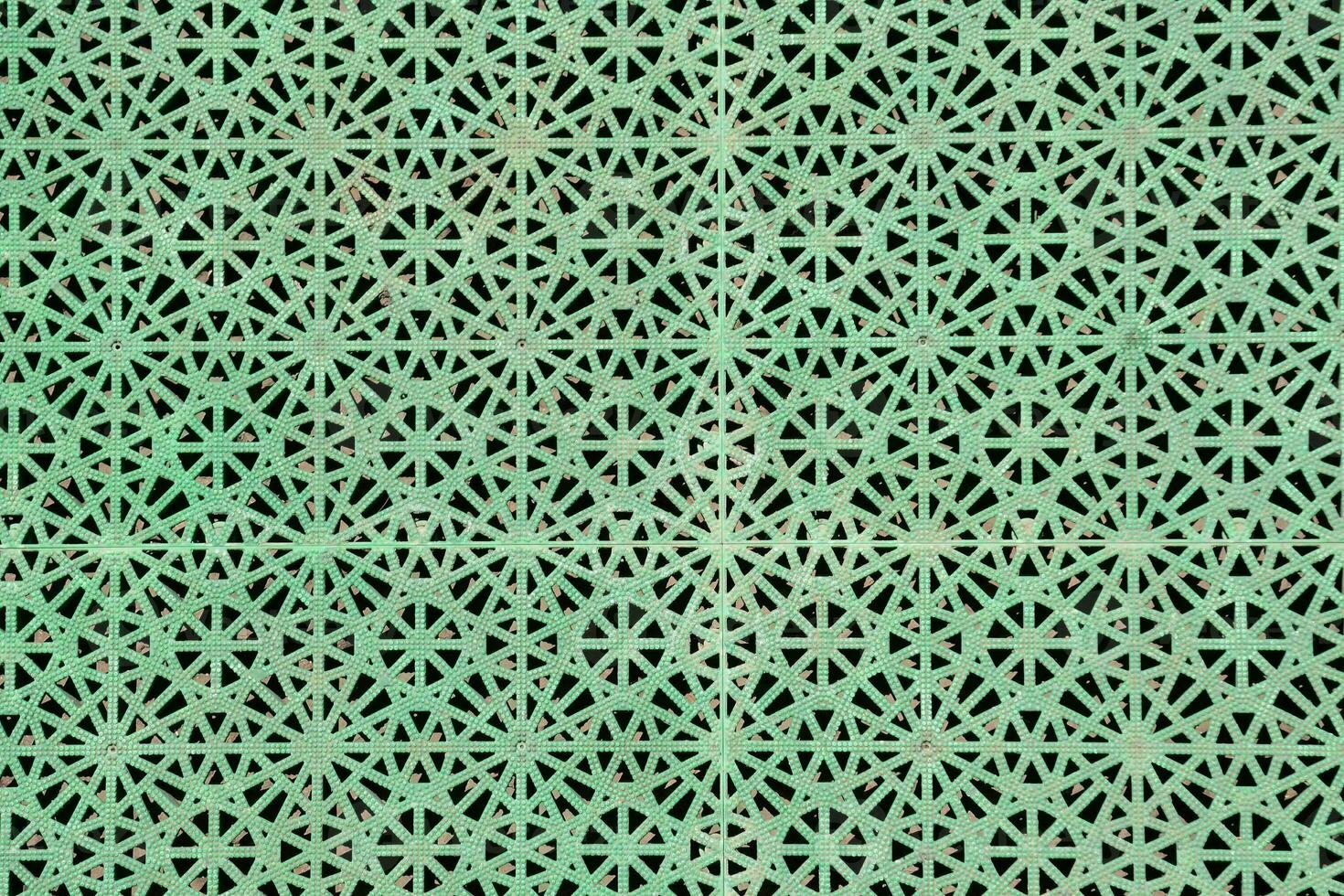 a green metal mesh with a pattern of stars photo