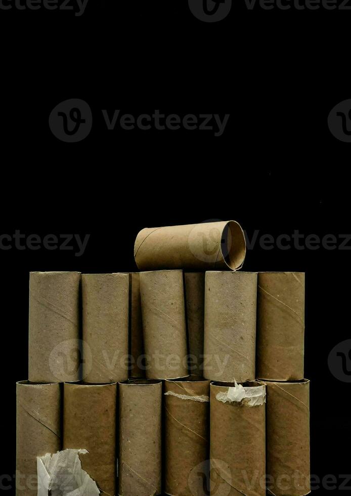 a pile of toilet paper rolls on a black background photo