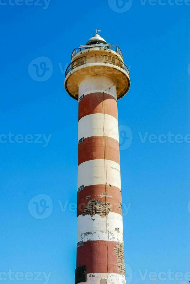 a red and white striped lighthouse photo