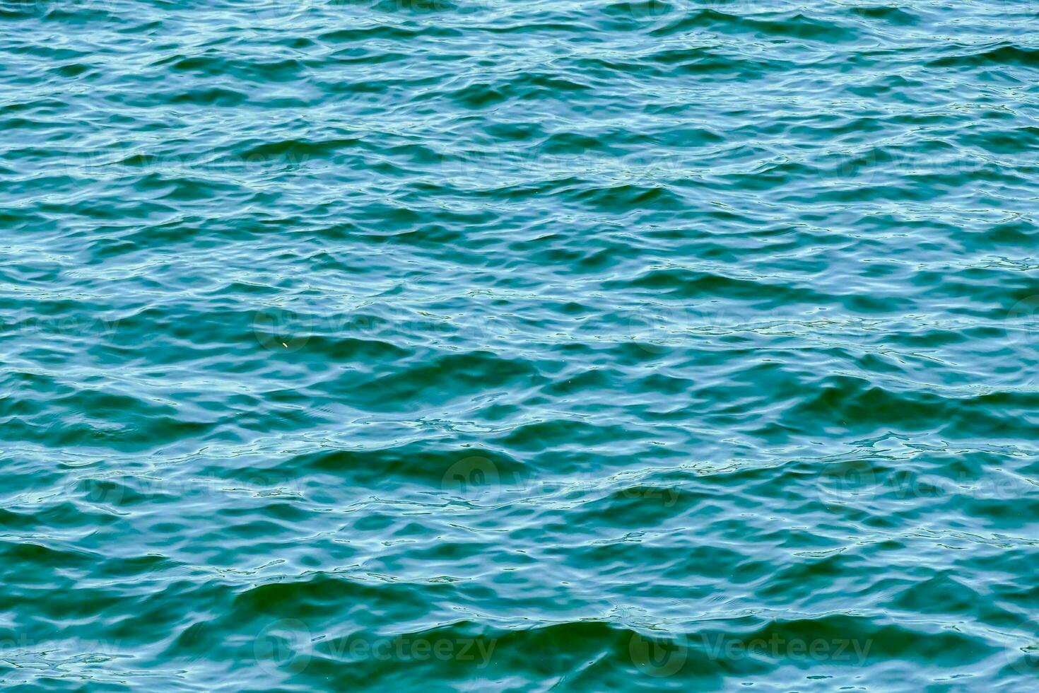 the surface of the water is blue and green photo