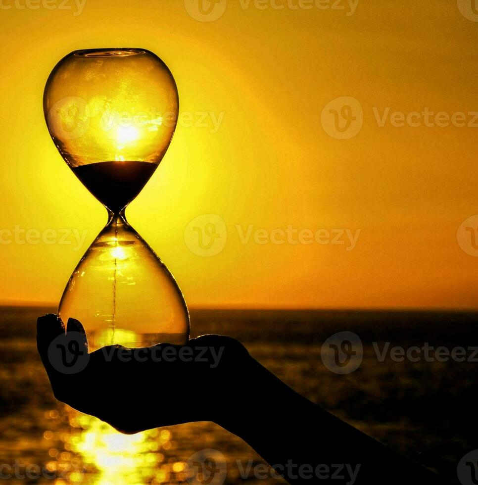 hourglass in front of the sun photo