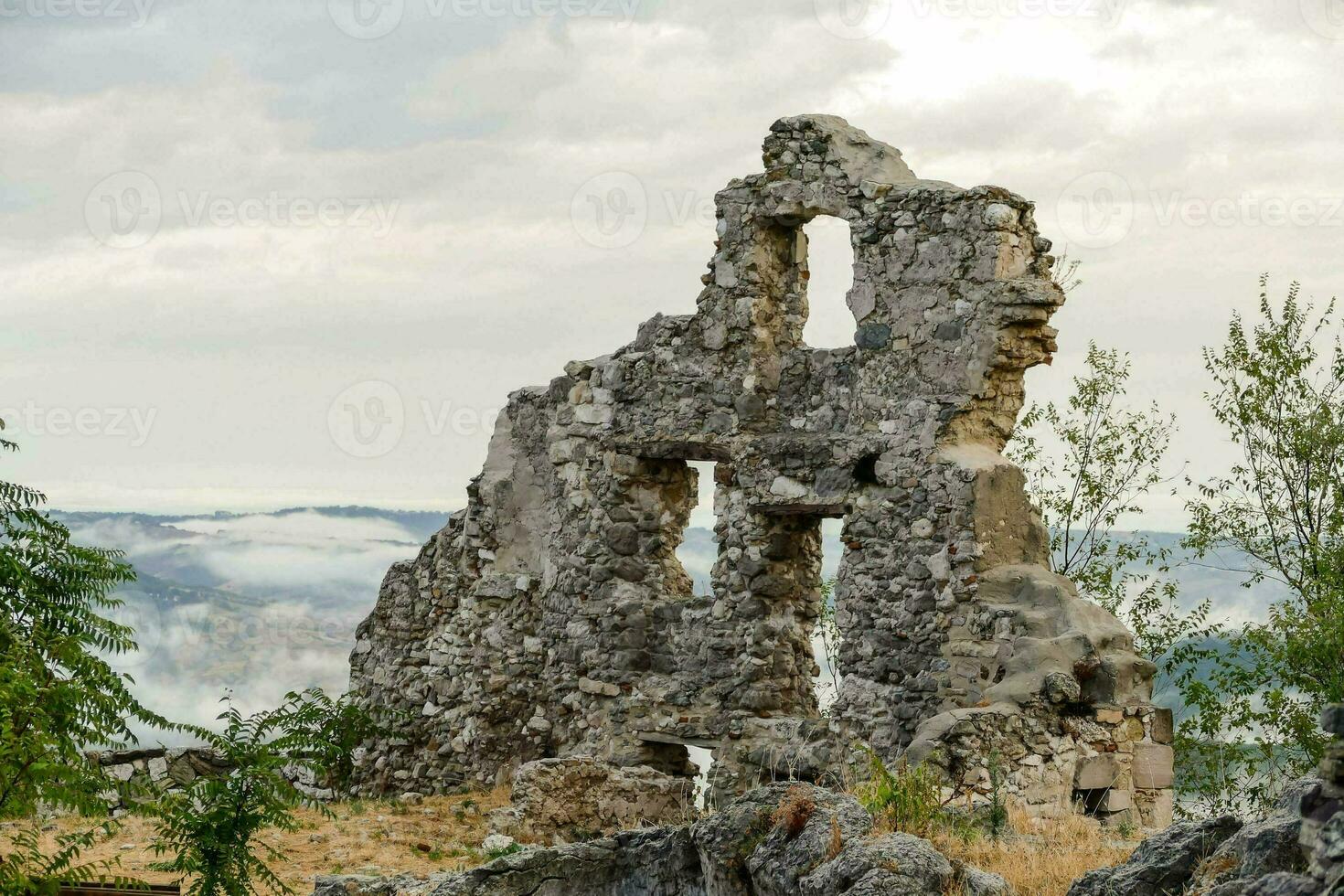 the ruins of an old castle in the mountains photo