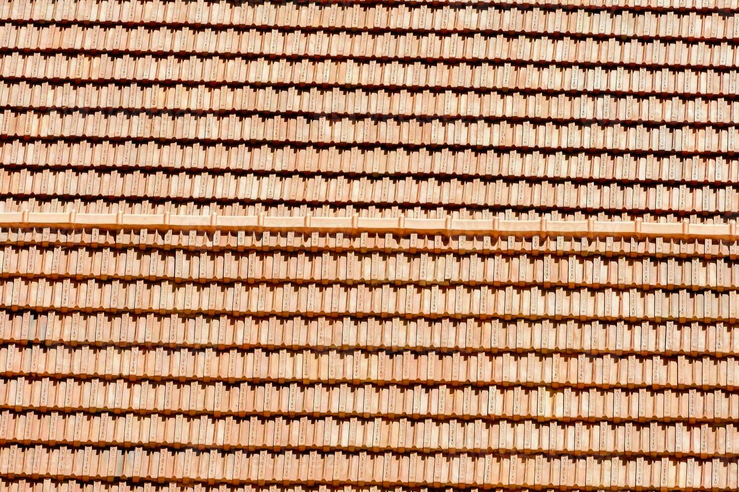 a close up of a red roof with many different tiles photo