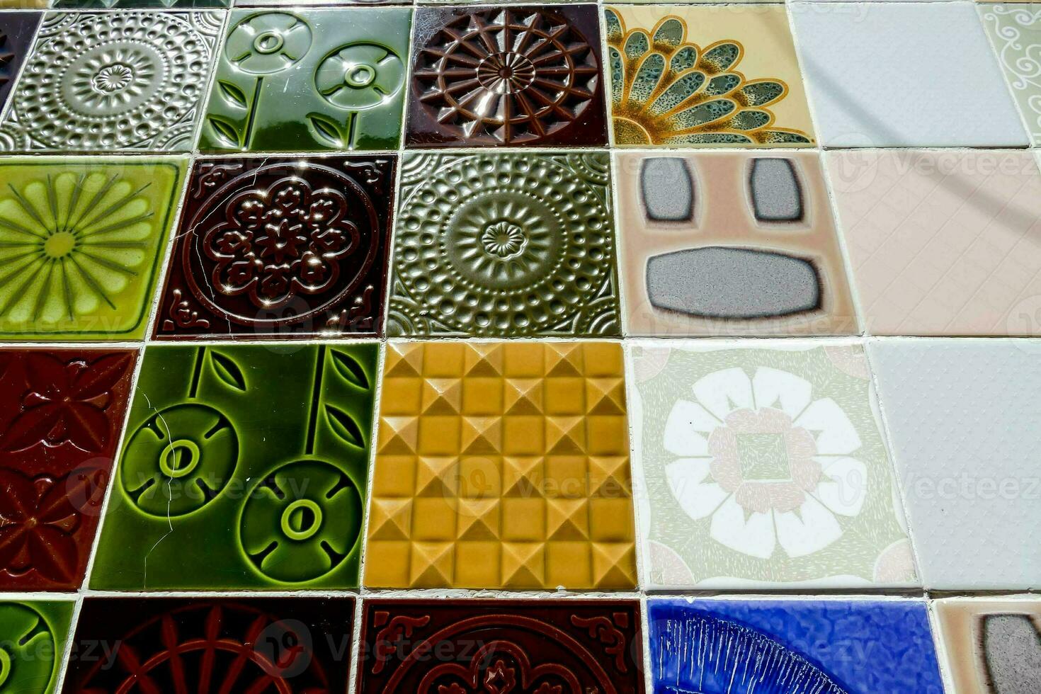 a colorful tile pattern with blue, green and red flowers photo