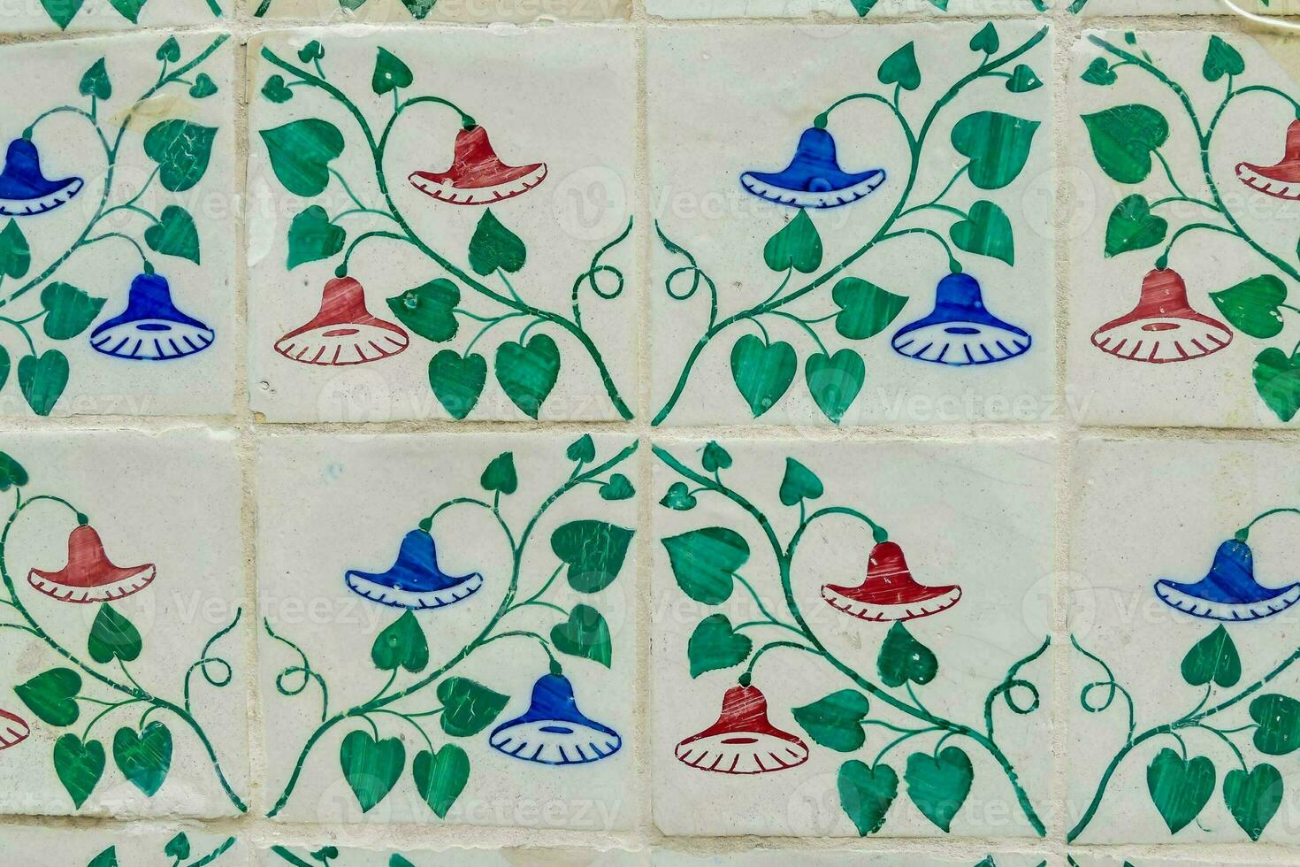 a colorful tile pattern with blue, green and red flowers photo