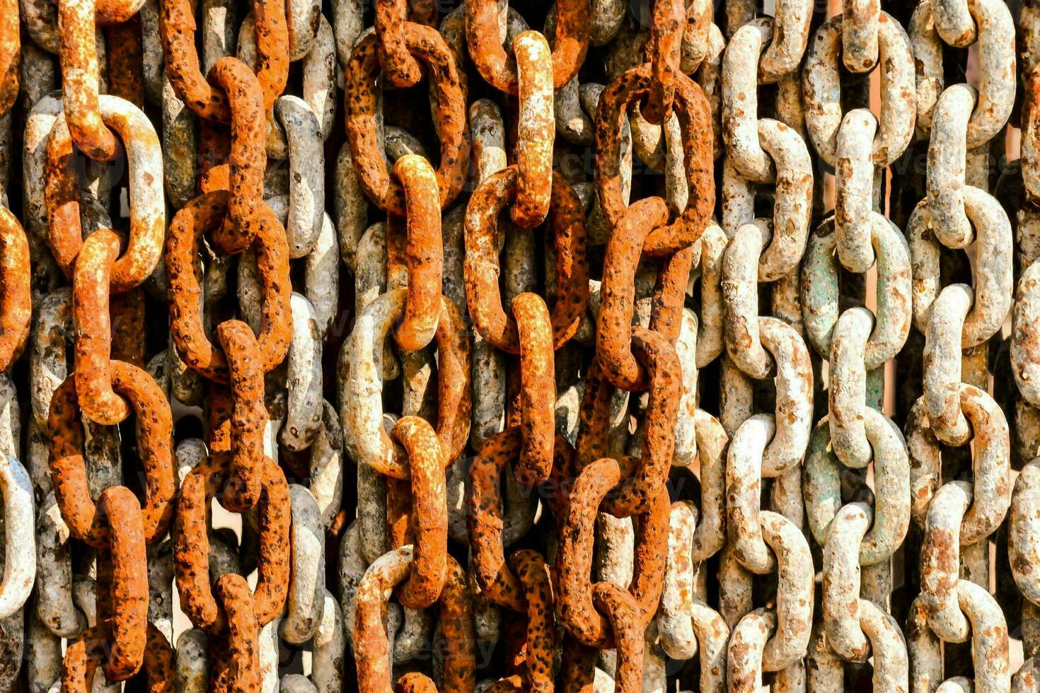 rusty chain links on a wall photo