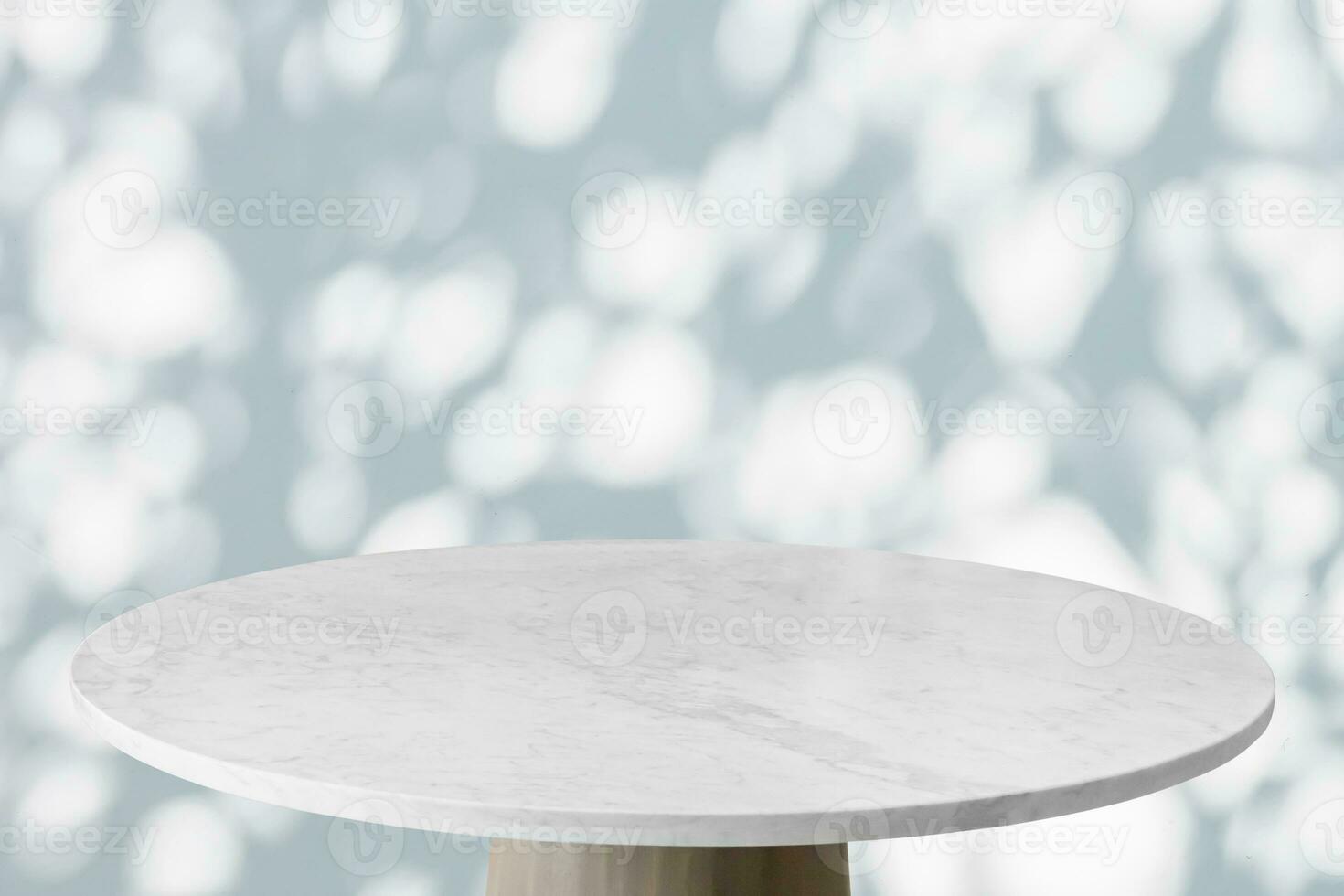 Round marble table top with tree leaves shadow drop on white wall background for mockup product display photo