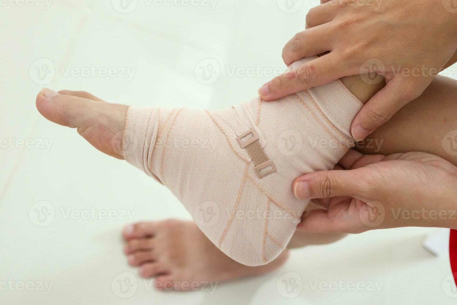 Man with ankle sprain elastic bandage for ankle injury and feeling pain photo