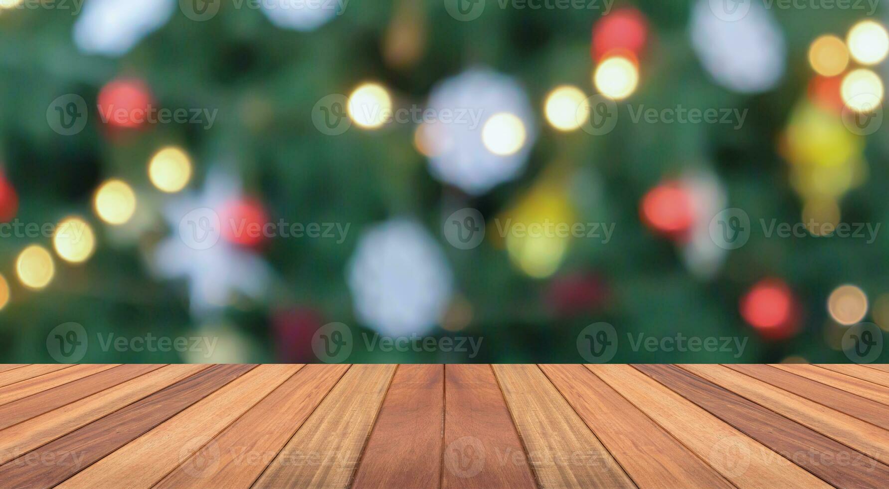 Empty wood table top with blur Christmas tree with bokeh light background photo