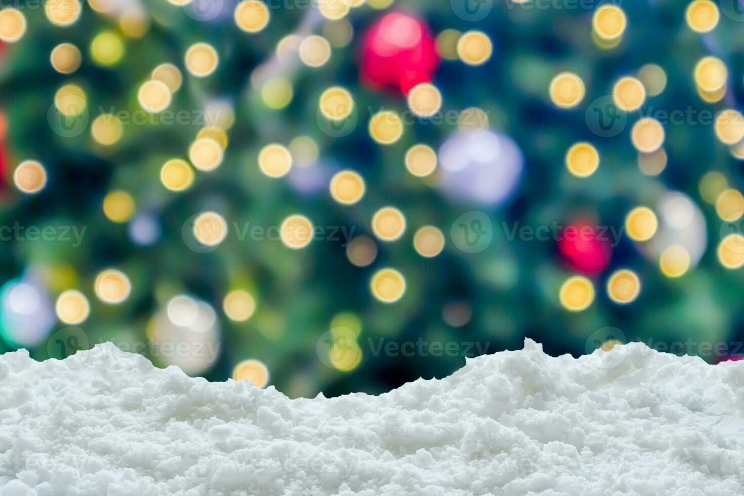 Empty white snow with blur Christmas tree with bokeh light background photo