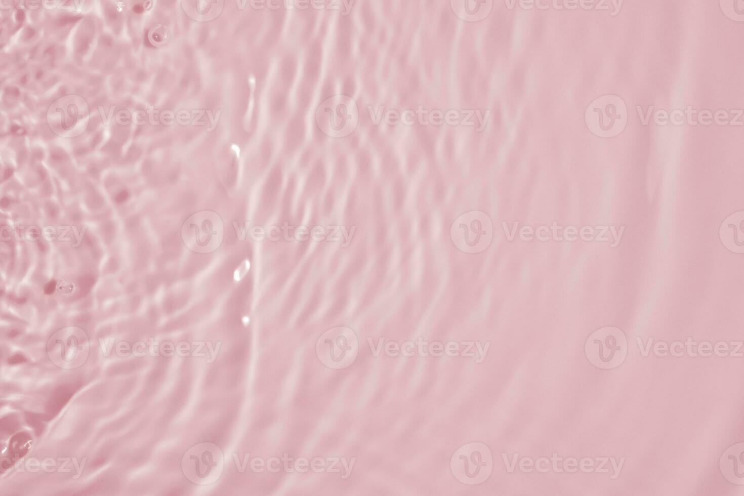 Abstract transparent water shadow surface texture natural ripple on pink background photo