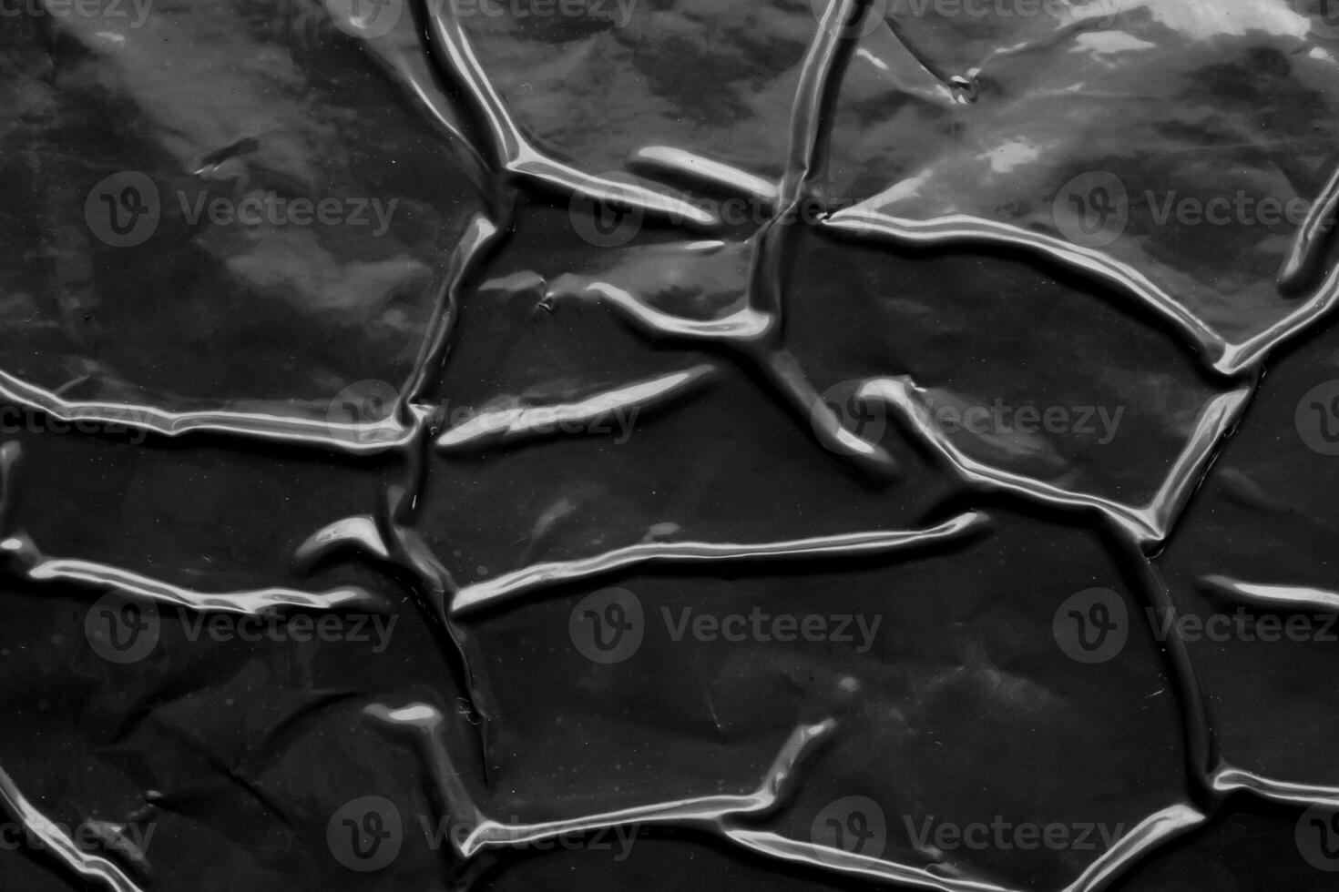 black crumpled and creased plastic poster texture background photo